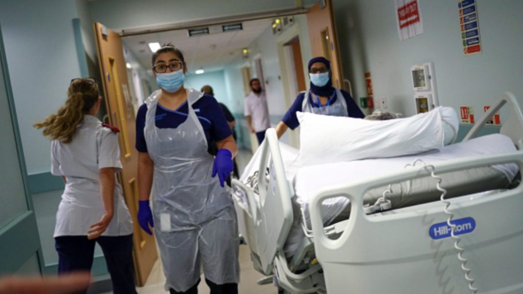 Medical staff transfer a patient along a corridor at The Royal Blackburn Teaching Hospital, operated by East Lancashire NHS Trust, in Blackburn, U.K., on Thursday, May, 14, 2020.