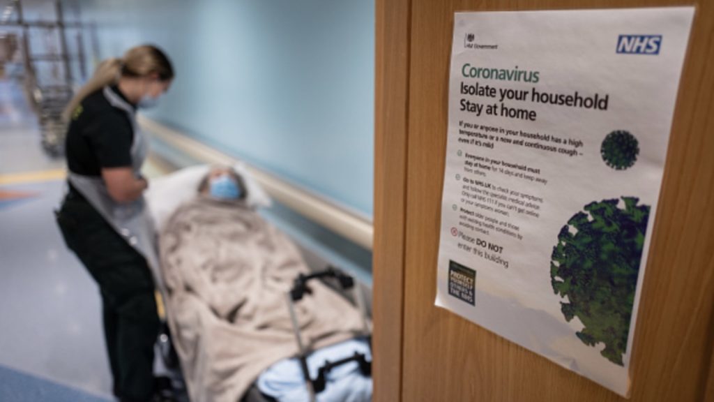 Katie Ffolloitt-Powell of the Patient Transport Services of South Central Ambulance Services speaks to an elderly non-COVID-19 patient as she is moved from hospital to a care home on May 05, 2020 near Portsmouth, England.