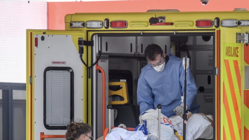 A doctor wearing protective equipment is seen unloading a patient outside St Thomas' Hospital on April 7, 2020 in London, England