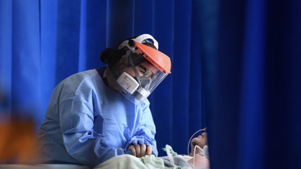 A member of the clinical staff wears personal protective equipment (PPE) as she cares for a patient at the Intensive Care unit at Royal Papworth Hospital in Cambridge, on May 5, 2020.