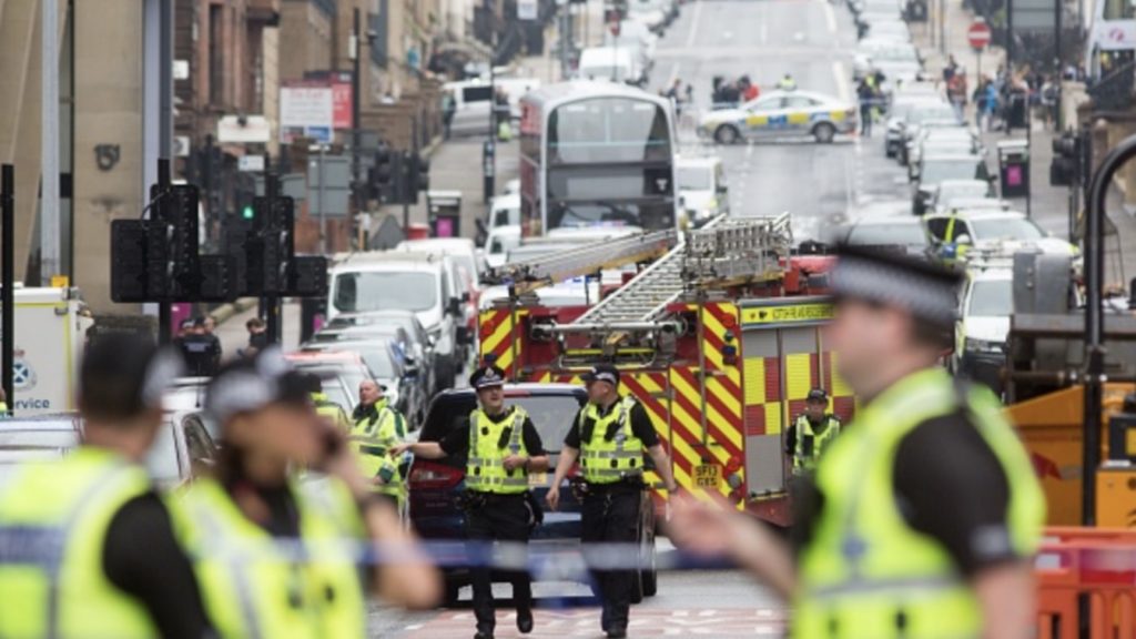 Police and other emergency services attend the scene of a fatal stabbing incident at the Park Inn Hotel in central Glasgow on June 26, 2020