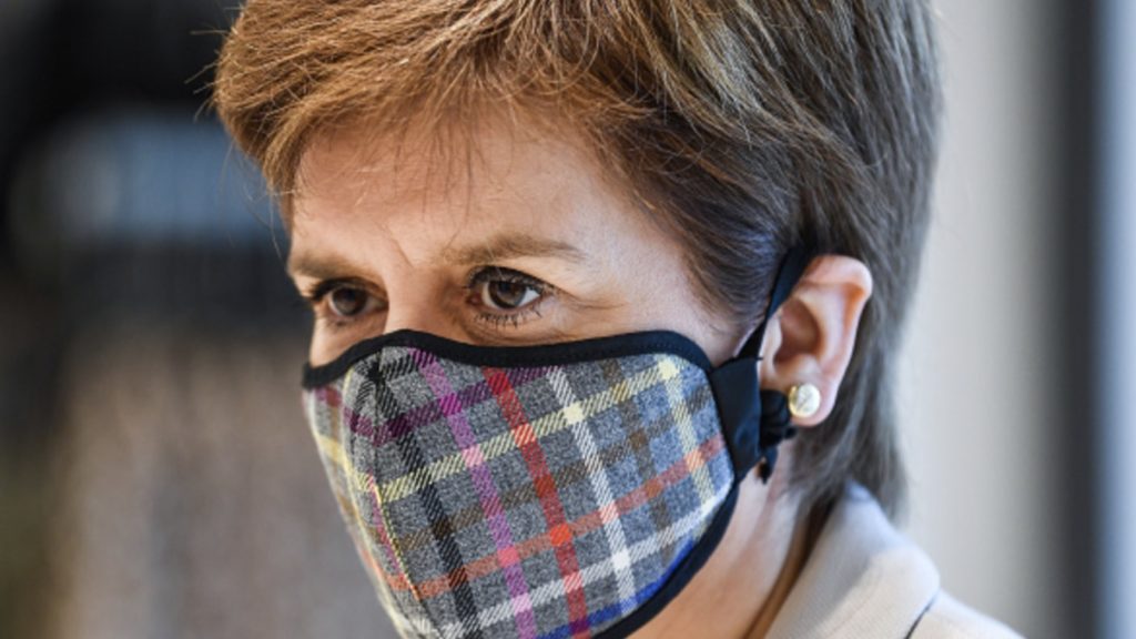 First Minister of Scotland Nicola Sturgeon wears a Tartan face mask as she visits New Look at Ford Kinaird Retail Park on June 26, 2020 in Edinburgh,Scotland