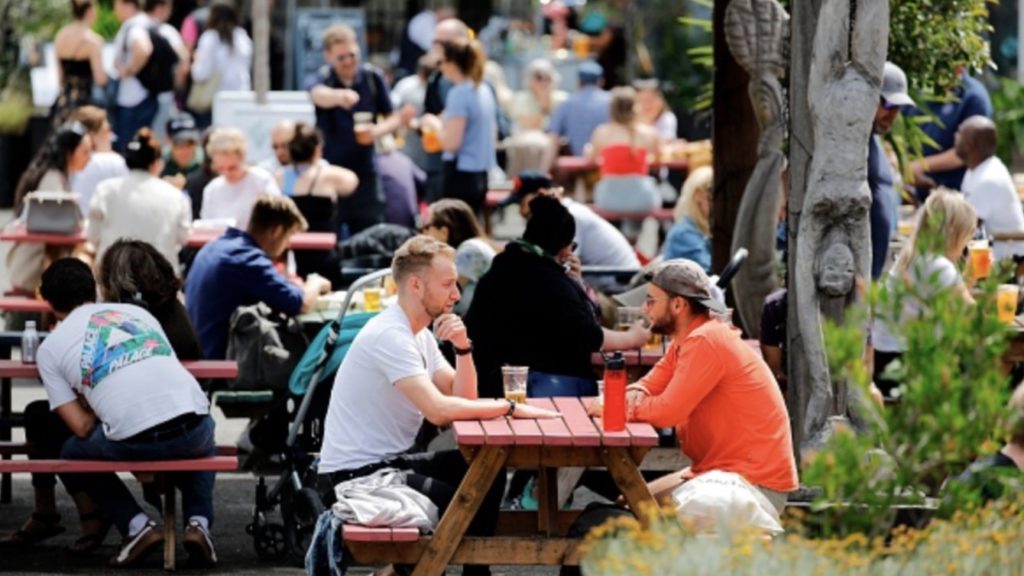 People enjoy a drink at Gabriel's Wharf beside the River Thames in London on July 3, 2020.